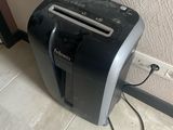 a black and silver toaster sitting on the floor next to a wall