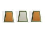three green and orange trays sitting next to each other on a white surface