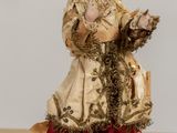 a figurine of a woman in a dress holding a cat