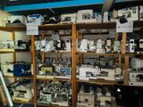 many different types of sewing machines on the shelves