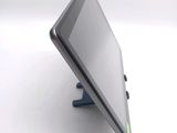 a tablet computer sitting on a stand on a white surface