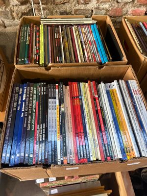 a lot of dvds in a box on the floor