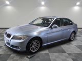 2011 bmw 3 series sedan in a showroom with a checkered floor