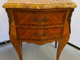 an antique wooden chest of drawers with a marble top