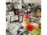 a table with many items on it including a purse and a pair of scissors