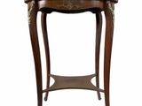 an image of a small table with a wooden top and gold decorations