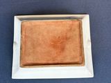 a small square plate with a piece of bread on it