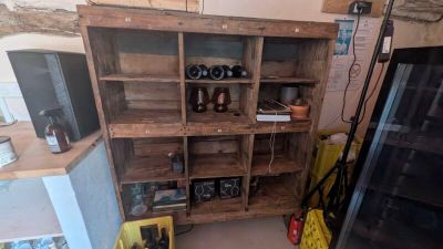 a wooden shelf that has a bunch of items on it
