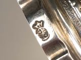 a close up of a silver plate with a clock on it