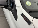 a sticker on the windshield of a white car