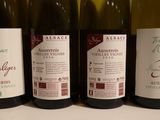 three bottles of wine are lined up on a table