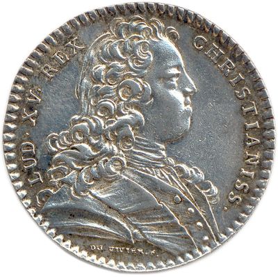 a close up of a coin on a white surface