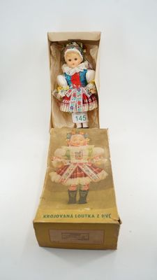 an image of a doll in a box on a white surface