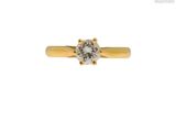 a yellow gold engagement ring with a single diamond