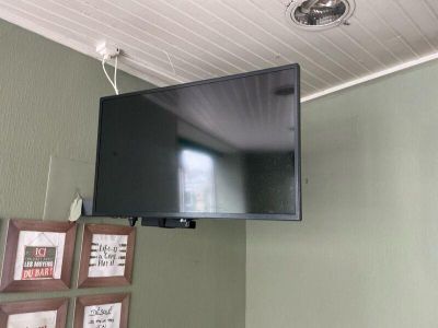 a flat screen tv mounted on the wall above a bed