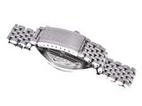 a close up of a watch on a white surface