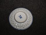 a small white plate with a blue design on it