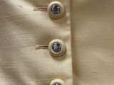 a close up of a jacket with buttons on it