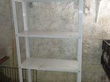 a white shelving with a shelf on it in a room