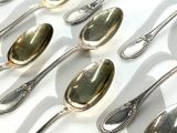 many spoons that are lined up together on a table