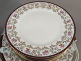a stack of plates on a plate holder with a gold handle