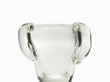 the glass cup is sitting on a white surface with a white background