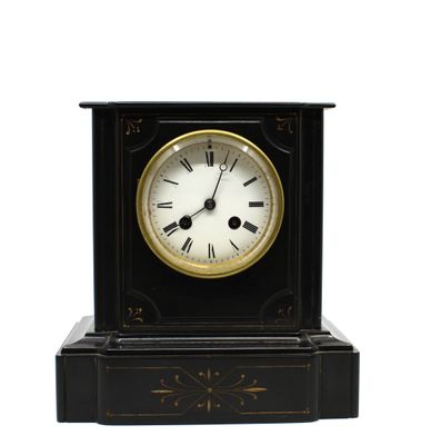 une horloge noire et dorée avec des chiffres romains