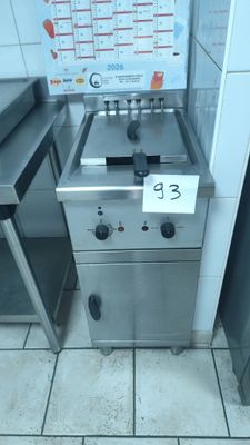 a silver stove with a sign on it in a kitchen