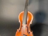 an old violin sitting on top of a table next to a wall