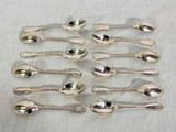 six spoons are arranged in a row on a table