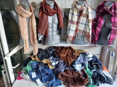 many scarves and scarves on display on a table