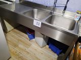 a stainless steel sink and a refrigerator in a kitchen