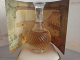 a bottle of perfume sitting on top of a glass table