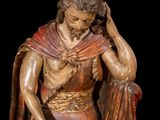 statue of a man in a red robe holding a red cloth