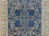 a blue rug with a floral design on it
