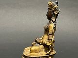an image of a statue of a person sitting on a pedestal