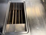 a stainless steel sink in the middle of a kitchen