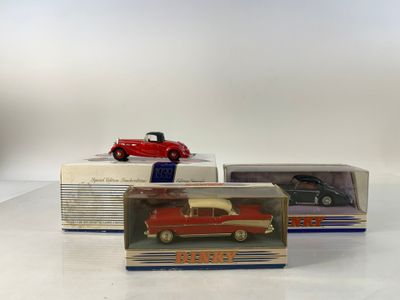 three boxed toy cars are sitting on top of a table