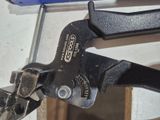 a close up of a pair of pliers hanging on a wall