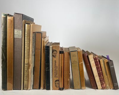 several old books are stacked on top of each other on a table