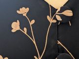 a close up of a dress with flowers on it on a mannequin mannequin