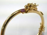 a close up of a gold ring with a cat on it