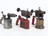three different types of antique tools are displayed on a white surface