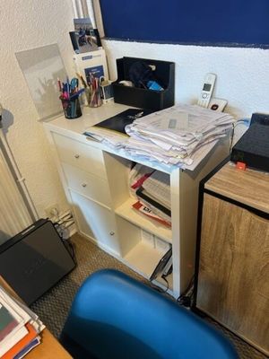 a desk with a laptop and a monitor on it