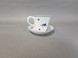a small cup and saucer sitting on a table