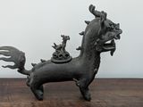 a small statue of a horse with a bird on its back