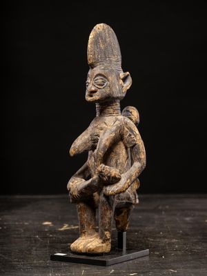 a wooden statue of a man with a hat on his head