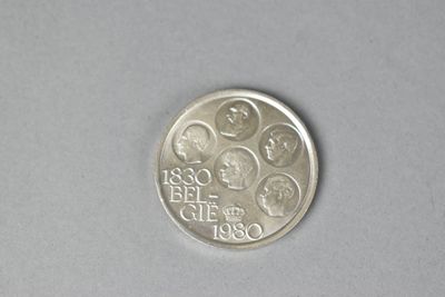 a silver coin with a picture on it on a table