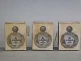 three boxes of perfume sitting on top of a table next to each other