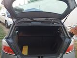 a car with its trunk open on the side of the road